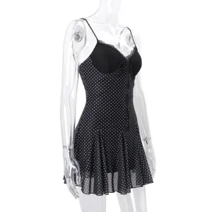 Detail of sexy black polka dot mini dress with lace trim and tie front on mannequin