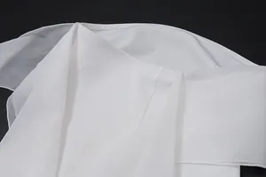 Close-up detail of a white French style strapless dress showing the elegant ribbon design