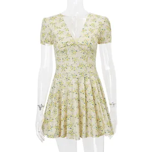 Front detail of a vintage floral V-neck dress with puff sleeves and pleated skirt on mannequin