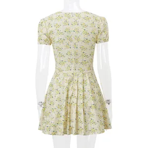 Back view of a yellow floral French retro dress with puff sleeves on a mannequin.
