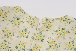 Detailed close-up showing back neckline and hidden zipper on yellow floral summer dress