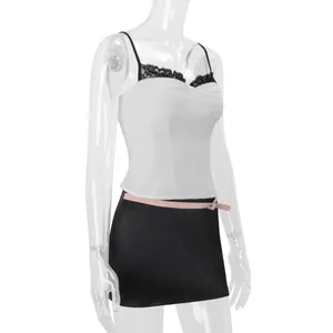 Detailed close-up of a white lace-trimmed camisole corset top displayed on a mannequin