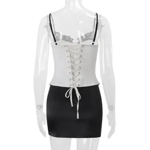 Detailed back view of a white lace-up corset top featuring black lace trim and ribbon tie