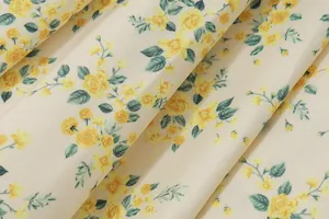 Close-up macro detail of yellow rose floral pattern on French vintage cream fabric texture