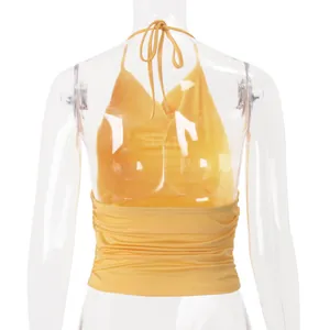 Back view detail of yellow halter crop top with backless design and self-tie neck