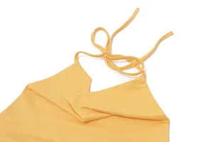 Close-up detail of a yellow summer halter neck top with adjustable tie strap and V-neckline.