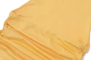 Macro close-up view showing the fine stitching and ruched yellow fabric of the halter top