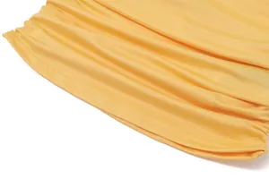Close-up of the yellow ruched fabric and fine stitching on the halter neck vest top