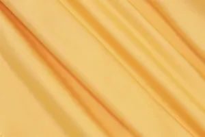 Macro detail shot showing the soft ribbed yellow fabric texture of a sexy halter top.