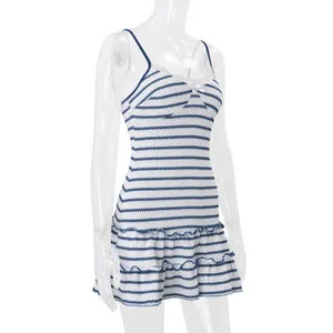 Detail view of blue and white striped camisole mini dress with tiered ruffle hem.