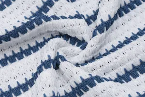 Close-up of the textured blue and white striped knit fabric of the summer dress