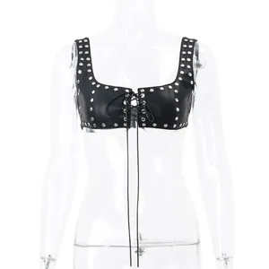 Detailed front view of black studded lace-up faux leather crop top on mannequin