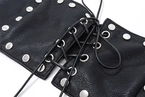 Close-up of black textured leather vest with silver studs and lace-up detail