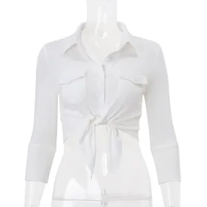 White cropped button-up shirt featuring a collar, chest pockets, and a front tie-knot detail.