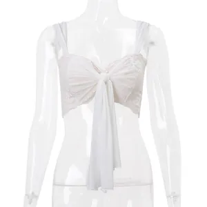 Vista frontale del top sexy in pizzo e mesh bianco con grande fiocco decorativo