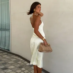 Elegant backless halter top and polka dot midi skirt set shown in a lifestyle shot