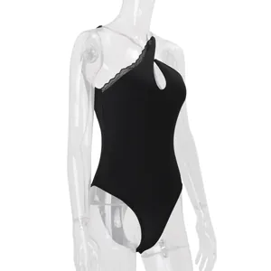 Detailed side view of a black one-shoulder bodysuit featuring lace trim and cutout