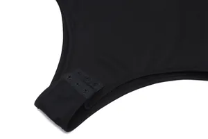 Close-up detail of the adjustable snap button closure on a black slim fit bodysuit