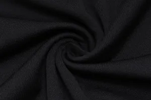 Macro view showing the high-quality black ribbed fabric texture and fine knit detail.
