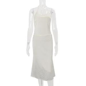 White satin polka dot two-piece set featuring backless halter top and midi skirt