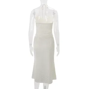 Back view of a sexy ivory halter neck backless top and matching polka dot midi skirt set