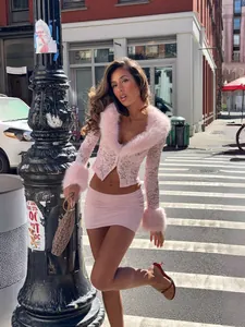 Stylish pink lace set with faux fur trim and mini skirt in urban street setting