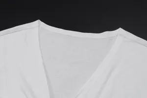 Macro view of high-quality V-neckline stitching on a white stylish summer top.