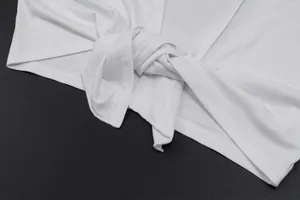 Detailed close-up view of the knotted tie-front design on a white summer shrug