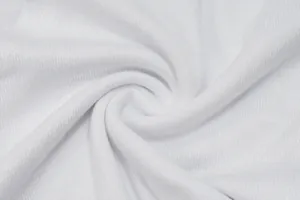 Macro detail shot showing the soft white knit fabric texture of this summer shrug top
