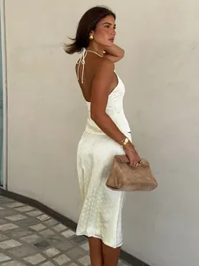 Elegant white satin halter top and midi skirt set with subtle polka dots for summer