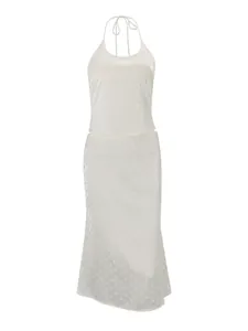 Elegant white halter top and midi skirt set with subtle tonal polka dot pattern.