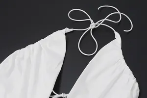 Close-up of halter-neck tie-up detail on a white sexy V-neck vest