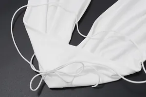 Close-up detail of white elastic halter camisole showing delicate lace-up ties and soft fabric