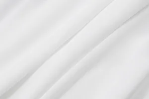 Detailed macro shot of the breathable white elastic fabric for the halter tank top.