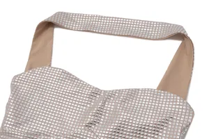 Close-up detail of shimmering silver square sequins on a nude halter neck bandeau dress