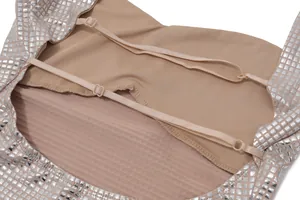 Detailed view of the adjustable straps and silver sequined square pattern on a bodycon dress