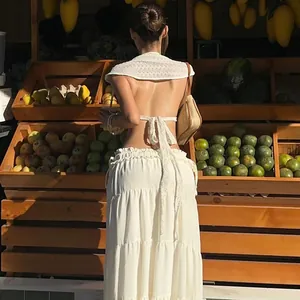 Back view of white hollow-out tie-back top with ruffle sleeves in sunny fruit market