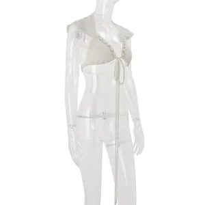 Detailed view of cream crochet lace-up crop top with shells and ruffle sleeves
