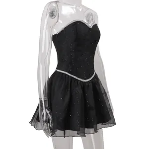 Side view of elegant black sparkling strapless mini dress with silver bead trim