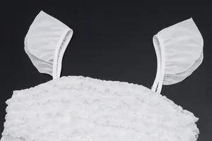 Detailopname van de witte mesh vlindermouwen en ruches op een top in de Franse stijl.