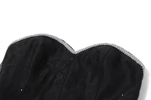 Close-up of black sweetheart neckline dress with silver braided trim and glitter fabric.