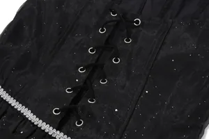 Close-up of black corset lace-up detail on shimmering princess birthday dress with silver trim