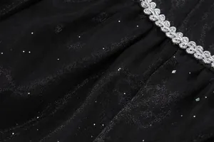 Detailed view of black princess dress fabric featuring silver sequins and elegant braided trim