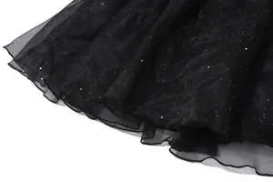 Close-up of black glitter mesh fabric showing sparkly details of the dress hem.
