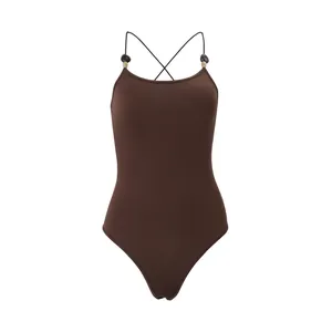 Close-up of brown sleeveless bodysuit with criss-cross straps and bead detail