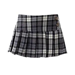 Close-up of vintage American style gray plaid pleated mini skirt with decorative metal buttons