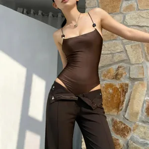Close-up of a sexy brown slim-fit sleeveless bodysuit with decorative bead straps