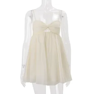Close-up detail of a beige chiffon camisole with a twist-knot front and thin straps