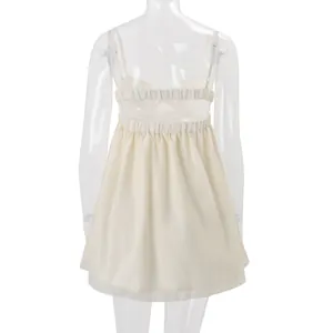 Back view of cream chiffon camisole top showing its elastic bands and thin straps