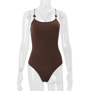 Detail view of a brown sleeveless bodysuit with beaded straps on a mannequin.
